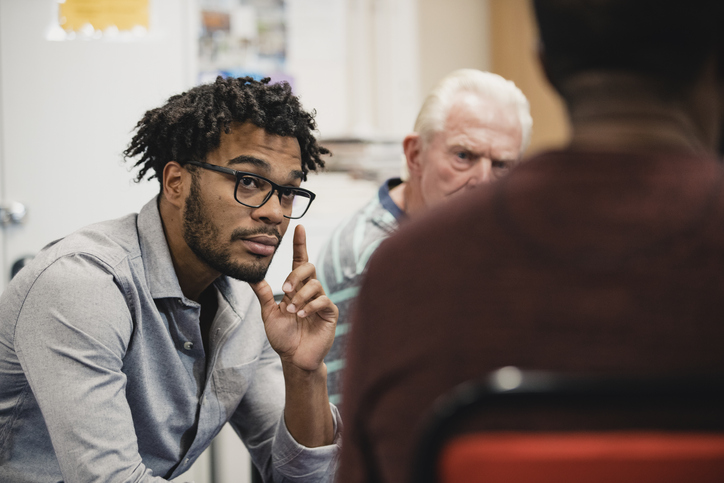 Close up shot of a mid-adult listening to someone speaking