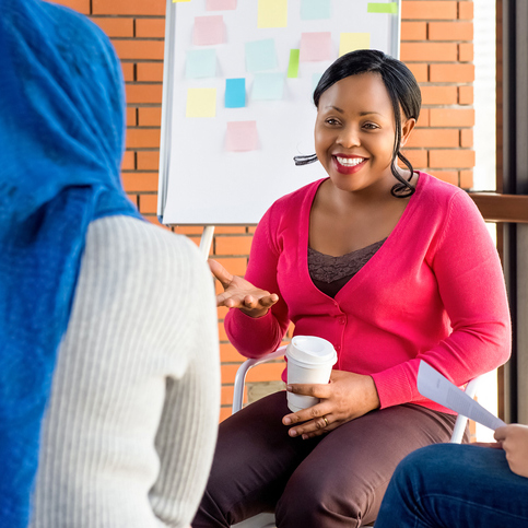 Diverse group of women in colorful clothes at a group meeting